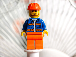 Fototapeta premium Russia, St. Petersburg, August 8, 2020 Close-up of a Lego man wearing a hard hat, ready for a construction site or a building adventure