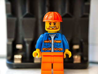 Fototapeta premium Russia, St. Petersburg, August 8, 2020 Close up of a Lego man wearing a hard hat, useful for illustrations and designs