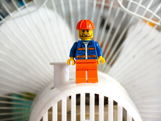 Fototapeta premium Russia, St. Petersburg, August 8, 2020 A lego man standing on top of a white fan, great for illustration, presentation or design