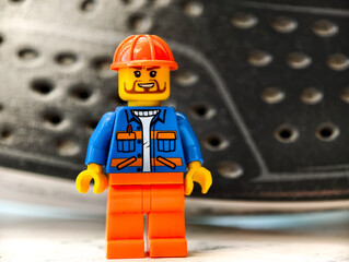 Fototapeta premium Russia, St. Petersburg, August 8, 2020 A close up of a Lego man wearing a helmet, suitable for use in illustrations or designs related to building, construction, or fantasy