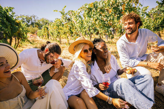 Friends sharing wine and enjoying a relaxed afternoon in a vineyard