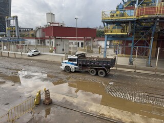 full loaded heavy dumper truck at stone sett paving wharf of seaport. © Iryna