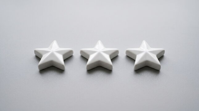 Three White Stars Rating: Three simple white star shapes arranged in a row, symbolizing a rating or feedback.