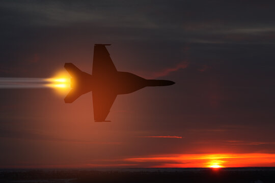 Air Force Day. Aircraft silhouette on background of sunset. Combat flight of interceptor on a mission.