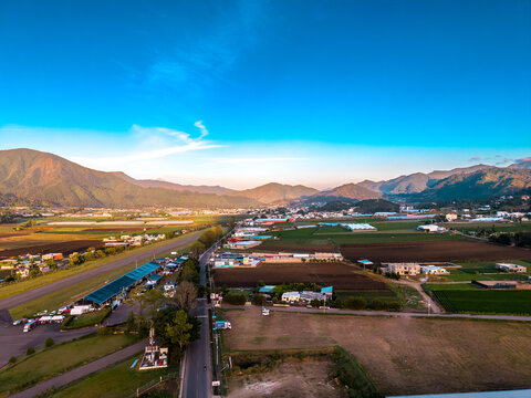 Aerial view of sunrise over the agricultural plantations and rolling mountains of the countryside in Constanza, La Vega Province, Dominican Republic.