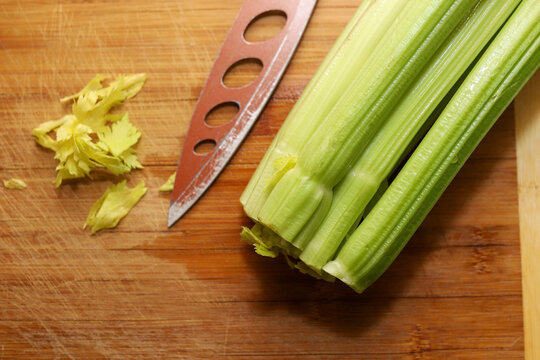Fresh organic celery on a wooden cutting board