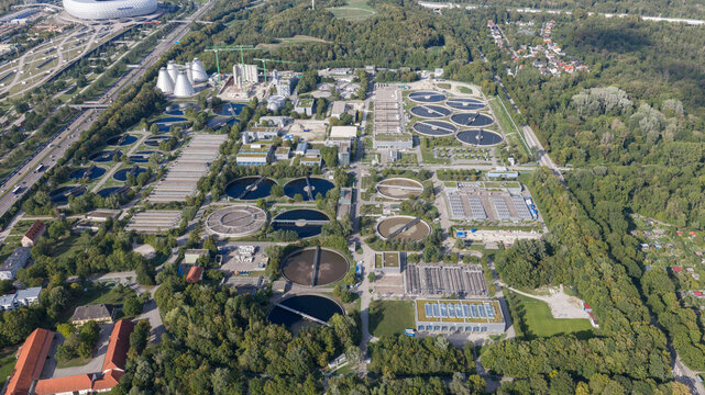 Aerial view of the WWTP Good Grosslappen wastewater treatment plant with circular sedimentation tanks and industrial infrastructure Munchen, Bayern, Germany.