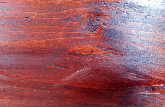 Polished cherry wood texture with natural knot detail and glossy reddish brown grain finish suitable for luxury timber tabletop and premium hardwood manufacturing.