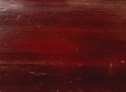 Dark crimson wood plank texture with deep red undertones offers moody atmospheric background for rustic interior design and high quality carpentry visualization.