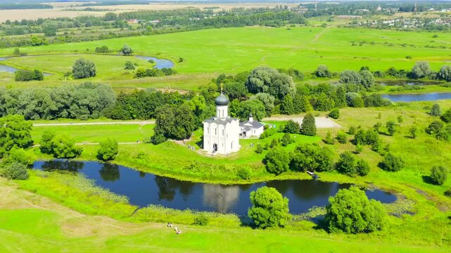 Russia, Bogolyubovo. Drone footage of Church of the Intercession on the Nerl. Orthodox church and a symbol of medieval Russia. Drone footage, Departure of the camera