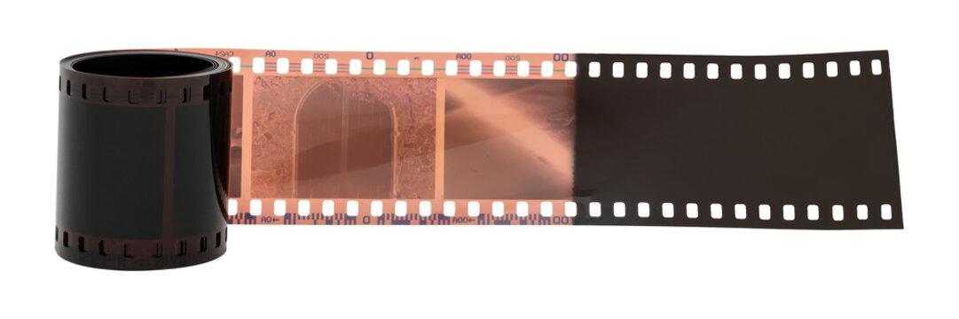 A roll of 35mm film partially unrolled, showing exposed frames.