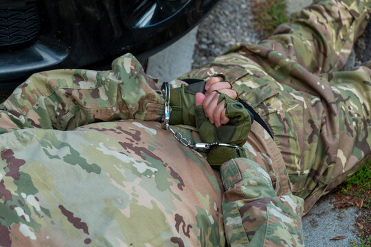 Staged arrest scene of a suspected military agent by counterintelligence during a security operation.