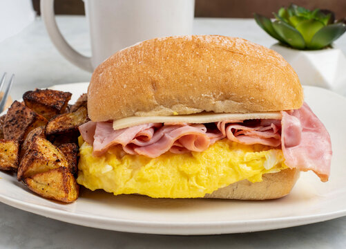 scrable egg breakfast sandwich with  home fries