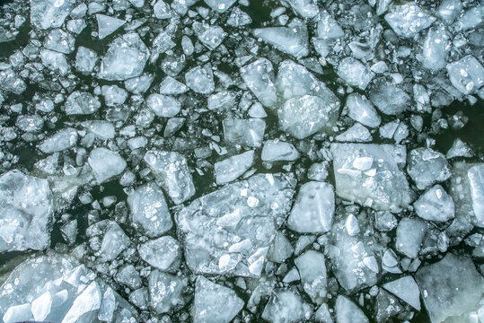 Floating ice pieces on water surface during winter