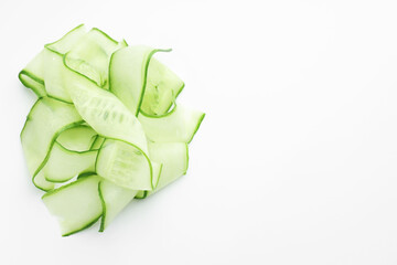 Obraz premium Slices of ripe cucumber on white background, top view. Space for text