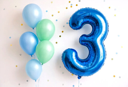 Bright blue number three balloon with colorful balloons celebration setup