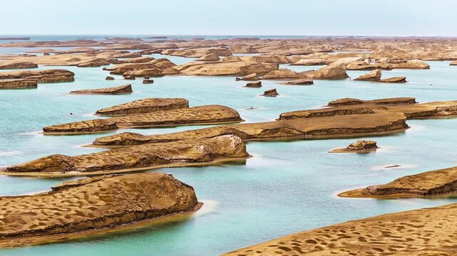 High angle elevated panoramic view of the unique water yardang landforms surrounded by turquoise lake waters in Qinghai, China.