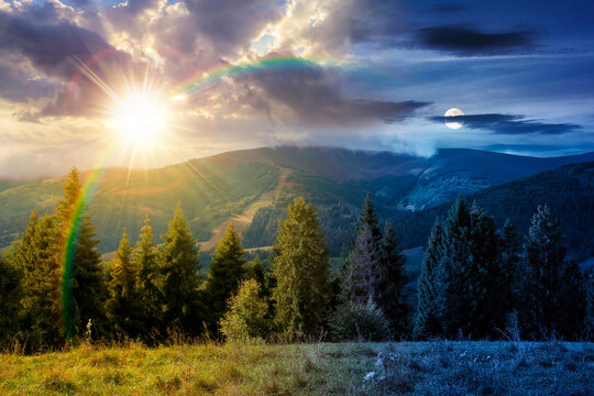 rural fields on autumn equinox. day meet night. sun and moon over trees on the grassy hills at twilight. beautiful countryside scenery of carpathian mountains. clouds on the epic sky