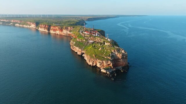 Aerial view Cape Kaliakra headland with dramatic red cliffs and blue Black Sea during sunset summer travel destination in Bulgaria slow motion video
