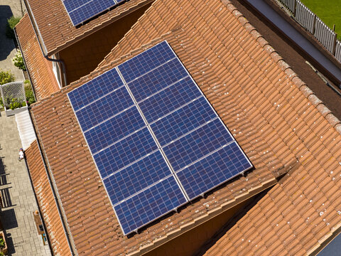 Aerial view of solar panels installed on a terracotta tiled roof in a residential area of Buch, Berlin, Berlin, Germany.