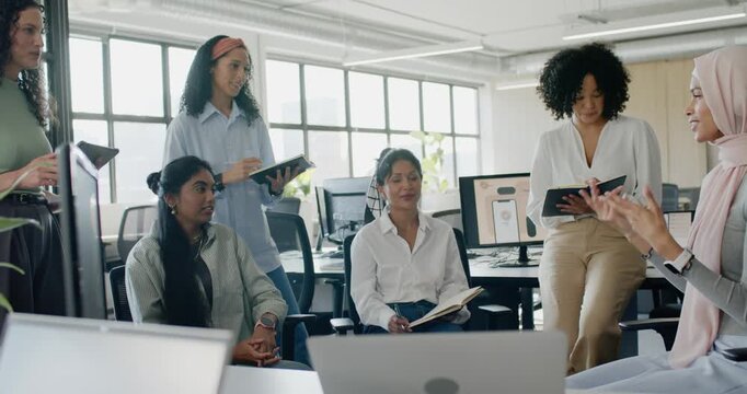 Diverse female team around laptop in office woman in hijab starting discussion taking notes to plan