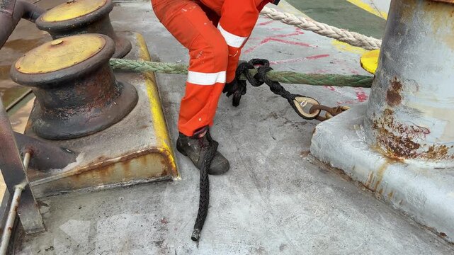 seafarer fix stopper to ship mooring line.