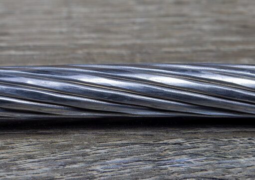 An aluminum conductor steel-reinforced (ACSR) bare overhead power line cable. A compacted stranded aluminum conductor
