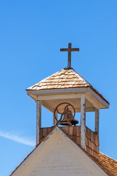 Steeple with brass bell on an old, abandoned church