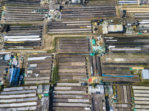 Aerial view of Bakolia Shutki Polli, a large-scale fish drying facility featuring numerous bamboo racks arranged in rows for processing fish in Chattogram, Chittagong Division, Bangladesh.