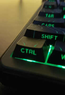Close up of illuminated computer keyboard with green backlight