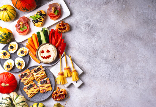 Halloween appetizers with pumpkin hummus deviled eggs and mummy snacks