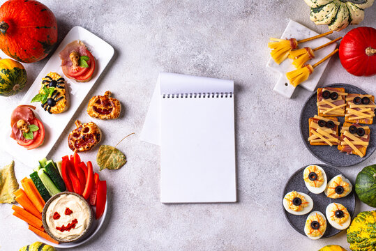 Halloween appetizers with pumpkin hummus deviled eggs and mummy snacks
