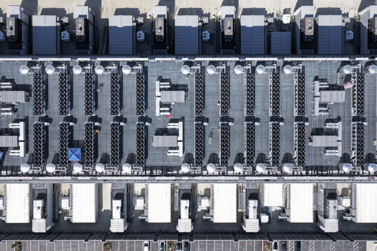 Aerial view of a large data center roof featuring rows of industrial cooling fans, HVAC units, and silver ventilation equipment in Reno, Nevada, United States.