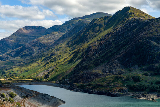 Rugged mountain slopes rising above Llyn Peris lake near Llanberis, steep rocky ridges stretching towards Snowdon peak in Yr Wyddfa, North Wales