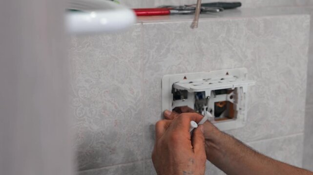 Installation of an internal flushing mechanism inside a concealed toilet cistern by a professional plumber