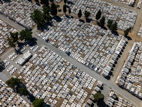 Aerial view of the cemetery with rows of white grave markers and narrow paths in Evora, Evora District, Portugal.