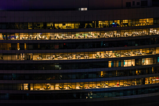 Aerial view of modern offices in the financial district with illuminated windows at night in Warszawa, Poland.