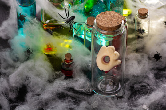 Halloween spooky potion bottles with spiders and cobwebs for decoration