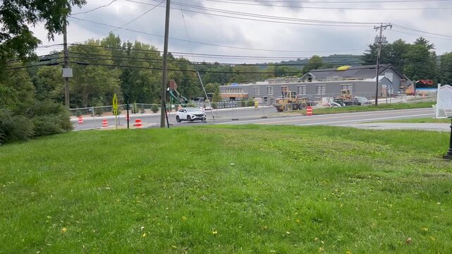 Building construction site with traffic on road