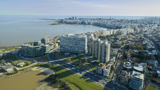 Aerial view of the Rambla del Buceo coastal road with high-rise residential buildings, urban greenery, and the bay in Montevideo, Departamento de Monte, Uruguay.
