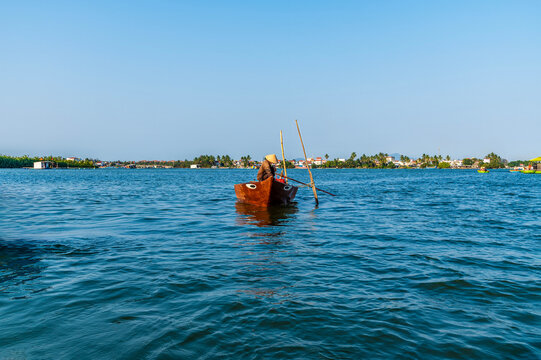 A view of a traditional fishing boat on the waterways of the Bay Mau coconut forest in Cam Thanh village near Hoi An, Vietnam on a bright sunny day