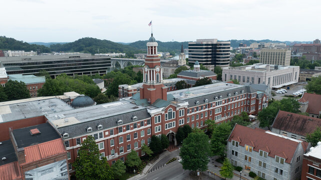 Aerial view of the Howard H. Baker, Jr. United States Courthouse with its clock tower, surrounded by historic brick buildings and lush trees in Knoxville, Tennessee, United States.