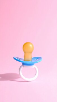 Blue Baby Pacifier on Pastel Pink Background Newborn Soother Dummy