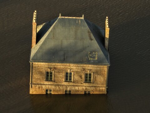 Coueron, France - 29 December 2025: Aerial view of La Maison dans la Loire, a surreal art installation appearing to sink into the river, with stone walls and a slate roof.
