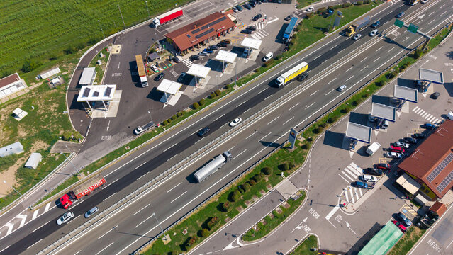 San Giuliano Milanese, Italy - 10 September 2026: Aerial view of a highway rest stop with gas stations, parking areas, and vehicles traveling along the road in Lombardy.