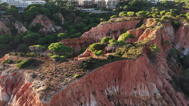 Falesia Beach, Algarve, Portugal. Golden mile beach with orange rocks, golden sand and turquoise sea. Aerial drone top view perspective. Famous travel destination in south of Portugal 
