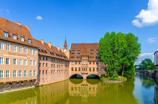 Nuremberg, Germany, July 14, 2024: Hospice Hospital of the Holy Spirit Heilig-Geist-Spital medieval building on bank of river Pegnitz in old town Nuremberg city historical center, Bavaria state