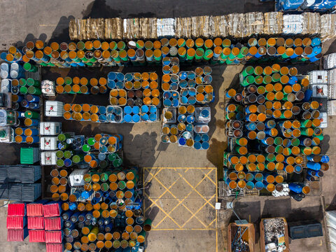 Stafford, United Kingdom - 13 September 2026: Aerial view of the Bostik facility, showing rows of colorful chemical barrels, storage containers, and marked loading zones on concrete.