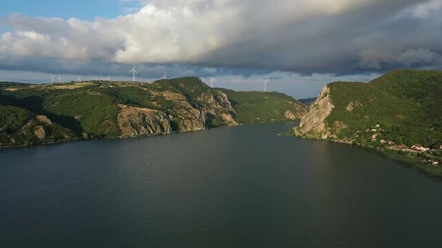 Aerial view on the Danube river and mountains in Djerdap National Park at sunset, Wind Turbines on hills, 4k