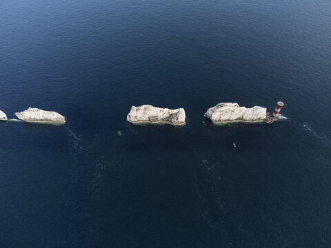 Isle of Wight, United Kingdom - 22 July 2021: Aerial view of The Needles, a series of distinctive chalk stacks rising from the sea with a lighthouse at the end.